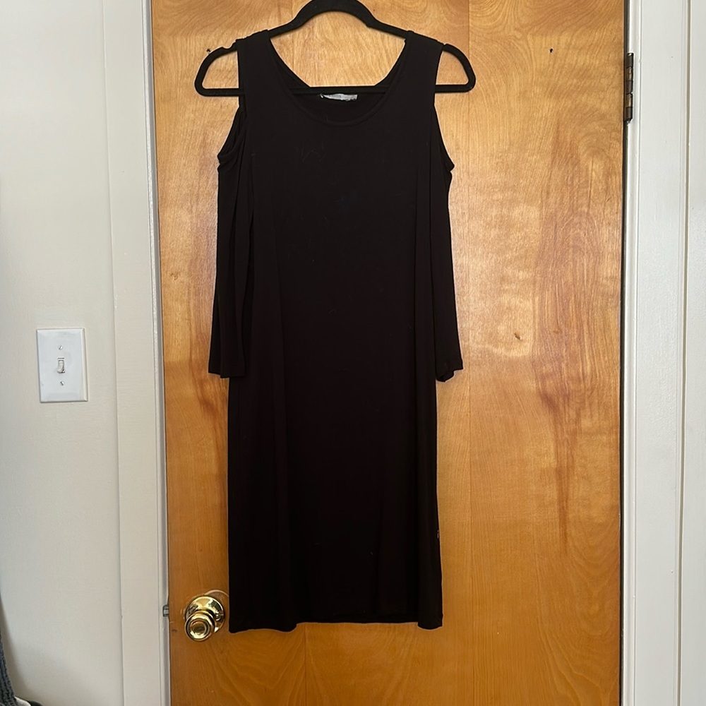 Knee-length black dress with shoulder cutouts